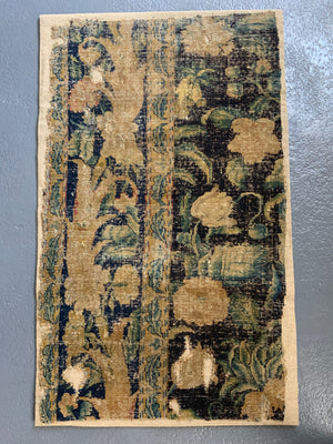 A Louis XIV Savonnerie carpet fragment (105 x 64cm)
